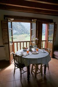 a table in a room with a view of a mountain at Mirador del Oso in Proaza