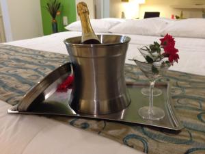 a tray with a bottle of champagne and a wine glass at Romantic Inn & Suites in Dallas