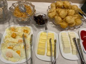 a table with plates of food on a table at Joan Guesthouse in Përmet