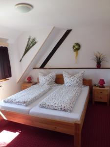 a bedroom with a bed with two pillows at Pension Wiesengrund in Schluchsee +46 photos