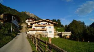 a house on a hill next to a road at Apart Mia in Brandberg