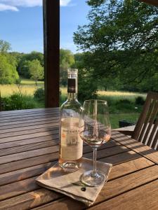 a bottle of wine sitting on a table with a glass at MaBelle rêve B&B in Saint-Pierre-de-Côle