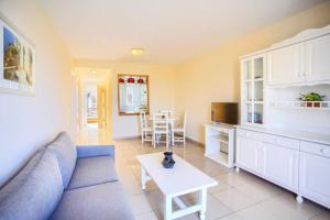 a living room with a couch and a table at El Veril 84 Bahia del Duque in Adeje