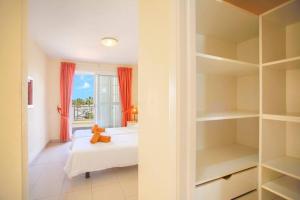 a bedroom with a bed and a book shelf at El Veril 84 Bahia del Duque in Adeje +16 photos