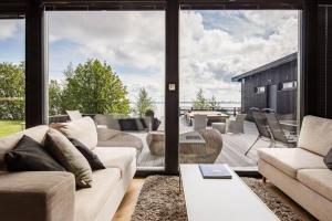a living room with a couch and a large window at Reelinki Seafront Villas, Villa Amando & Villa Aava in Pori
