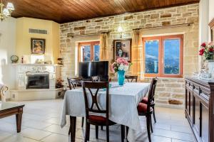 a dining room with a table and chairs at Ktima Edem in Ramní