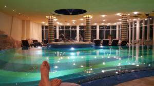 a person laying on the floor next to a swimming pool at Studio mit Seeblick in Bad Segeberg