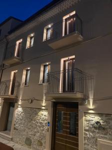 a building with two balconies on top of it at Le Benedettine Affittacamere Relais in Fondi