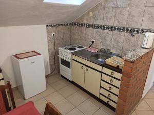 a small kitchen with a stove and a sink at Sara in Kamenari
