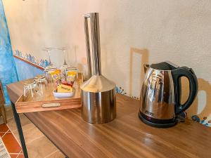 a tea kettle sitting on a wooden table at Hotel Boutique Santo Cuervo in Bernal