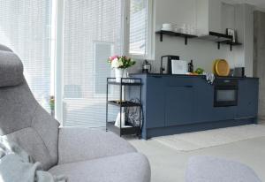 a living room with a blue cabinet and a chair at Villa Vassøy in Stavanger