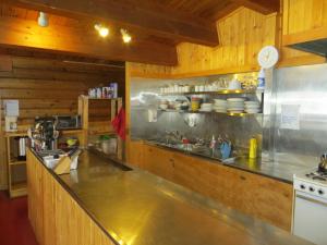 a kitchen with a stainless steel counter top at HI Kananaskis Wilderness - Hostel in Kananaskis Village