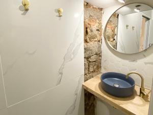 a bathroom with a blue sink and a mirror at Studio d'architecte centre historique in Ajaccio