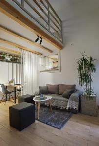 a living room with a couch and a table at Zona Apartments 1 in Zrenjanin