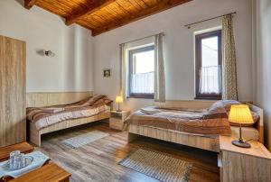 A bed or beds in a room at Rózsabarack Vendégházak