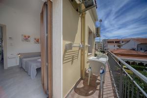 a balcony with a bedroom and a bed on a balcony at Casa Lucia in Olbia