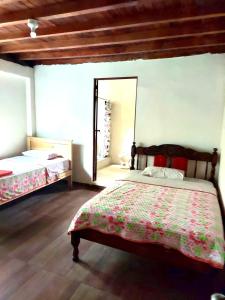 a bedroom with a bed and a mirror at Candurumy Lodge in Tena