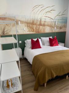 a bedroom with a large bed with red pillows at TY STUDIOS Hyper Centre Ville in Brest
