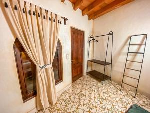 a room with a curtain and a window and a staircase at Hotel Boutique Santo Cuervo in Bernal +248 photos