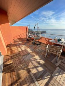 balcone con tavolo, sedie e vista sull'oceano di Appartement avec vue exceptionnelle sur mer a Cerbère