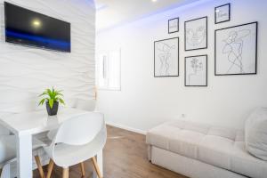 a white living room with a white couch and a table at JURE in Sali