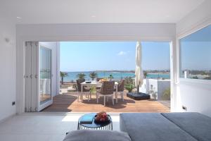 a bedroom with a view of the ocean from a balcony at The view 3 in Santa Marina