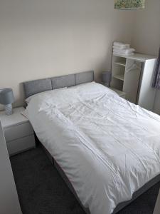 sypialnia z dużym łóżkiem z białą pościelą w obiekcie Seaview Ballintoy w mieście Ballintoy