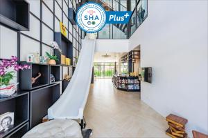 a slide in the lobby of a store at Book a Bed Poshtel - SHA Plus in Phuket