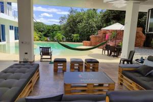 a patio with a hammock and a swimming pool at Quinta SHADDAI MELGAR in Melgar