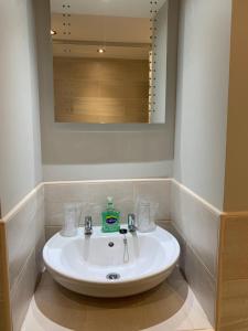 a white sink in a bathroom with a mirror at The Ivy in Lincolnshire
