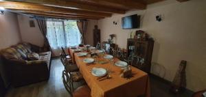 a table in a living room with a table and chairs at Balla House in Tărcaia