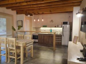 una cocina con una mesa y un refrigerador en Centinelas del Paraiso, en Villa La Angostura
