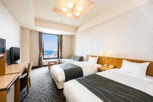 a hotel room with two beds and a television at Hotel Nord Otaru in Otaru +76 photos