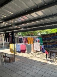 an outdoor market with clothes hanging on racks at RGC Residences in Tarlac