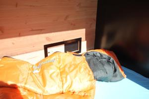 una tabla de snowboard en una cama en una habitación en StrandGutkoje auf dem Campingplatz Strandgut en Cuxhaven