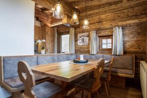 a dining room with a wooden table and chairs at Christernhof in Maria Alm am Steinernen Meer