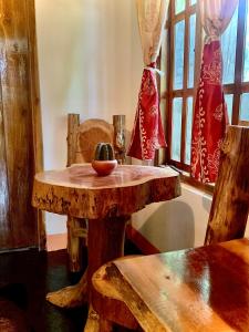 a wooden table with a bowl of fruit on it at Drift in Arugam Bay