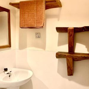 a bathroom with a sink and wooden crosses on the wall at Drift in Arugam Bay