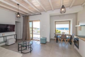 a living room with a view of the ocean at Porto Bello Tinos in Agios Ioannis