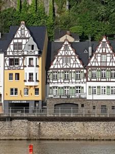 a group of buildings next to the water at Haus Burgfrieden Cochem in Cochem