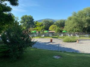 
a park with trees and lawn chairs at B&B Oasi Vetoio in LʼAquila
