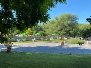 
a park with benches and trees and a lake at B&B Oasi Vetoio in LʼAquila
