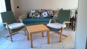 a living room with two chairs and a couch at Balatonpart-lak in Balatonfenyves