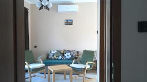 a living room with a couch and chairs and a table at Balatonpart-lak in Balatonfenyves