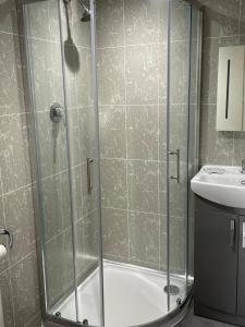 a bathroom with a shower and a sink at Sandford Promenade in Blackpool
