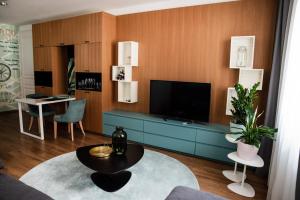 a living room with a tv and a blue cabinet at ATRIO Apartments in Trenčín