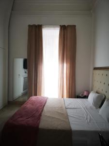 Postel nebo postele na pokoji v ubytování Hotel Valentino