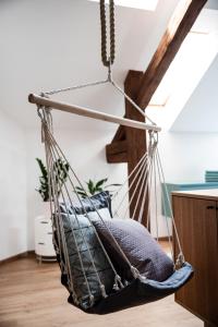 a hanging hammock chair in a room at ATRIO Apartments in Trenčín