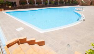 a large swimming pool with a tile floor at MEDANO4YOU Cabezo at Marineda in El Médano