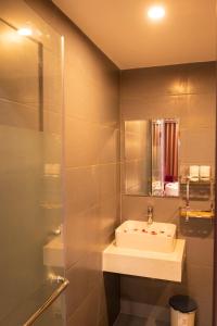 a bathroom with a sink and a mirror at Lavie Hotel in Hanoi